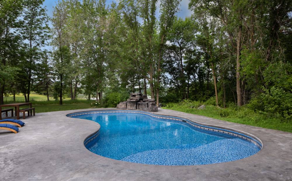Ground-level view of showcase free-form pool, featuring custom free-form steel steps Ground-level view of showcase free-form pool, featuring custom free-form steel steps